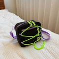 Kids black nylon crossbody bag with green bungee cord and purple zipper accents - Black