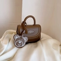Mini brown kids' crossbody bag with a cute bear charm and a smooth leather finish - Brown