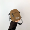 Brown corduroy crossbody bag with zipper pockets and adjustable black fabric strap - Brown
