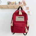 Mochila escolar de lona roja para niños con parche de moda y bolsillo delantero - Rojo