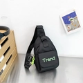 Black canvas chest bag for kids featuring neon green Trend letters and adjustable strap - Black