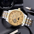 Detailed close-up of gold-silver automatic watch dial with sun-moon phase and open heart - Two-tone Gold Dial