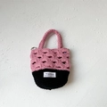 Pink and black crochet handbag for kids featuring hand-woven hollow patterns and handles - Pink