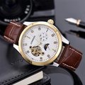 Macro view of mechanical watch face with moon phase and brown leather strap detail - Two-tone Case White Dial Brown Strap