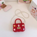 Red mini silicone jelly bag for girls featuring cartoon floral charms and pearl strap - Red