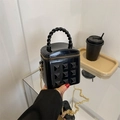 Mini black glossy quilted bucket bag with pyramid studs and gold chain strap - Black