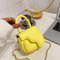 Mini bright yellow handbag with melting wave design, heart detail, and gold chain strap - Yellow