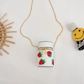White cylinder crossbody bag with strawberry embroidery and gold chain strap - White