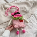 Pink hand-knitted girl cartoon crossbody bag with strawberry decor and ruffled dress detail - Pink