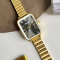 Macro shot of gold rectangular watch dial with Roman numerals and sunburst texture - Gold Black Face