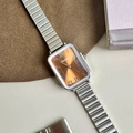 Detail of vintage rectangular watch with orange dial and silver stretch metal band - Silver Case Brown Dial