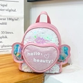 Pink sequin girls backpack featuring heart-shaped pocket and glittery wing details - Pink White