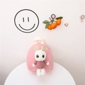 Pink canvas kids backpack with a 3D plush rabbit doll wearing a purple sweater - Pink