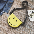 Mini yellow semi-circle crossbody bag for girls featuring a black smiley face print - Yellow
