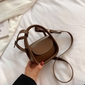 Chic brown mini leather crossbody bag for children with round handle and slim strap - Brown