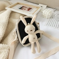 Kids black canvas crossbody bag with white plush rabbit doll and adjustable strap - Black