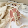 Pink canvas crossbody bag for children featuring a cute plush bunny doll and woven strap - Pink