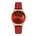 Detailed view of red leather strap and rose gold star and moon dial on lady's watch - Red