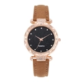 Detailed macro of starry black dial watch with rose gold case and rhinestone bezel - Brown