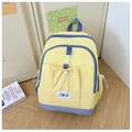 Detail of yellow nylon kids backpack with purple zipper and elastic drawstring design - Yellow