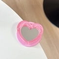Macro view of a pink glitter heart phone grip with a built-in makeup mirror detail - Pearl Heart Mirror-Rose Red