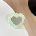 Macro shot of mint green heart-shaped phone grip with glitter frame and makeup mirror - Pearl Heart Mirror-Light Green