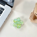 Macro detail of 3D flower phone grip with green and blue sequins on a desk - Sakura Holder Macaron Sequin No. 6