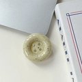 Gros plan du support de téléphone en résine crème avec taches noires et style bouton - Taches d'encre - Jaune Clair