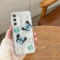 Funda transparente con purpurina y mariposas 3D azules con pedrería sujetada a mano - Mariposa Azul Zafiro (Marco Galvanizado-Epoxi Con Purpurina) / Samsung A16