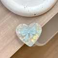 Macro detail of heart-shaped magnetic phone grip with rhinestone border and blue bow - Transparent Stand - Shell Heart - Jelly Bow / Blue