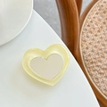 Détail du support de téléphone en cœur avec paillettes et miroir central sur table - Support Miroir Cœur - Cristal à Paillettes / Jaune Pâle