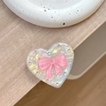 Macro shot of heart-shaped phone grip featuring pink bow and sparkling rhinestones - Transparent Stand - Shell Heart - Jelly Bow / Rose Red