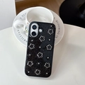 Detail of black glitter phone case with silver floral accents leaning on a coffee cup - Silver Bead Hollow Flower / iPhone 17 Pro Max