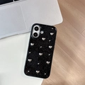 Macro shot of black glitter iPhone case featuring 3D silver heart-shaped metal accents - Silver Bead Mini Heart / iPhone 17 Pro Max