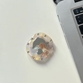 Macro shot of seashell texture dolphin phone grip with sparkling rhinestone accents - Transparent Grip - Marbled Square Dolphin Mirror - Beige Gray