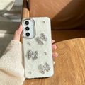 Detail of glitter phone case with silver bows, rhinestones, and lens protection ring - Electroplated Frame - White Glitter Drip Glue - Electroplated Butterfly / Samsung A16