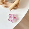 Detail of glitter flower phone socket with red and pink sequins on a white table - Sakura Grip - Colorful Sequins No.7
