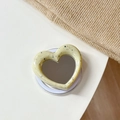 Detail of cream heart MagSafe phone grip with mirror surface and black ink splatters - Magnetic Heart Mirror Ink Splash-Light Yellow