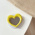 Macro shot of heart-shaped magnetic phone grip with yellow splatter pattern and mirror - Magnetic Heart Mirror Ink Splash-Dark Yellow
