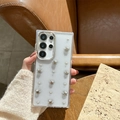 Detail of transparent Samsung case with silver stars, pearls, and metal camera protection - Samsung A16 / Electroplated Frame - Glitter Resin - Silver Bead Star