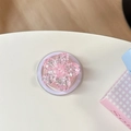 Detalle de soporte para móvil con flor de cerezo rosa brillante y base redonda - Magnético - Flor de Cerezo con Lentejuelas Brillantes / Rosa