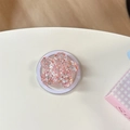 Primer plano de un soporte para móvil de flor de resina rosa con purpurina e imán - Magnético - Flor de Cerezo con Lentejuelas Brillantes / Rojo