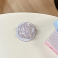 Vista dall'alto di un supporto per cellulare a fiore viola glitterato con petali acrilici - Magnetico - Ciliegio con Paillettes ad Alta Lucentezza / Viola