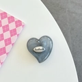 Macro shot of grey glitter heart phone socket with a metal handmade text badge detail - Silver Grey