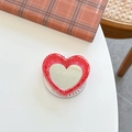 Detail of red glitter heart phone grip featuring a built-in mirror on a white desk - Ancorra Red