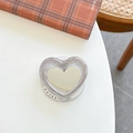 Macro shot of glittery heart phone grip mirror with Gift for You text base on a table - Coffee Grey