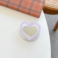 Glitter purple heart phone socket with built-in mirror on a plaid notebook background - Purple