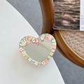 Detail of heart-shaped phone socket with mirror and fruit slices in clear resin - Pink