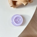 Macro shot of a lavender purple round button-shaped phone grip with pearl finish texture - Crystal Light Purple