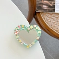 Macro shot of heart-shaped glitter mirror phone stand with fruit slice resin details - Dark Green